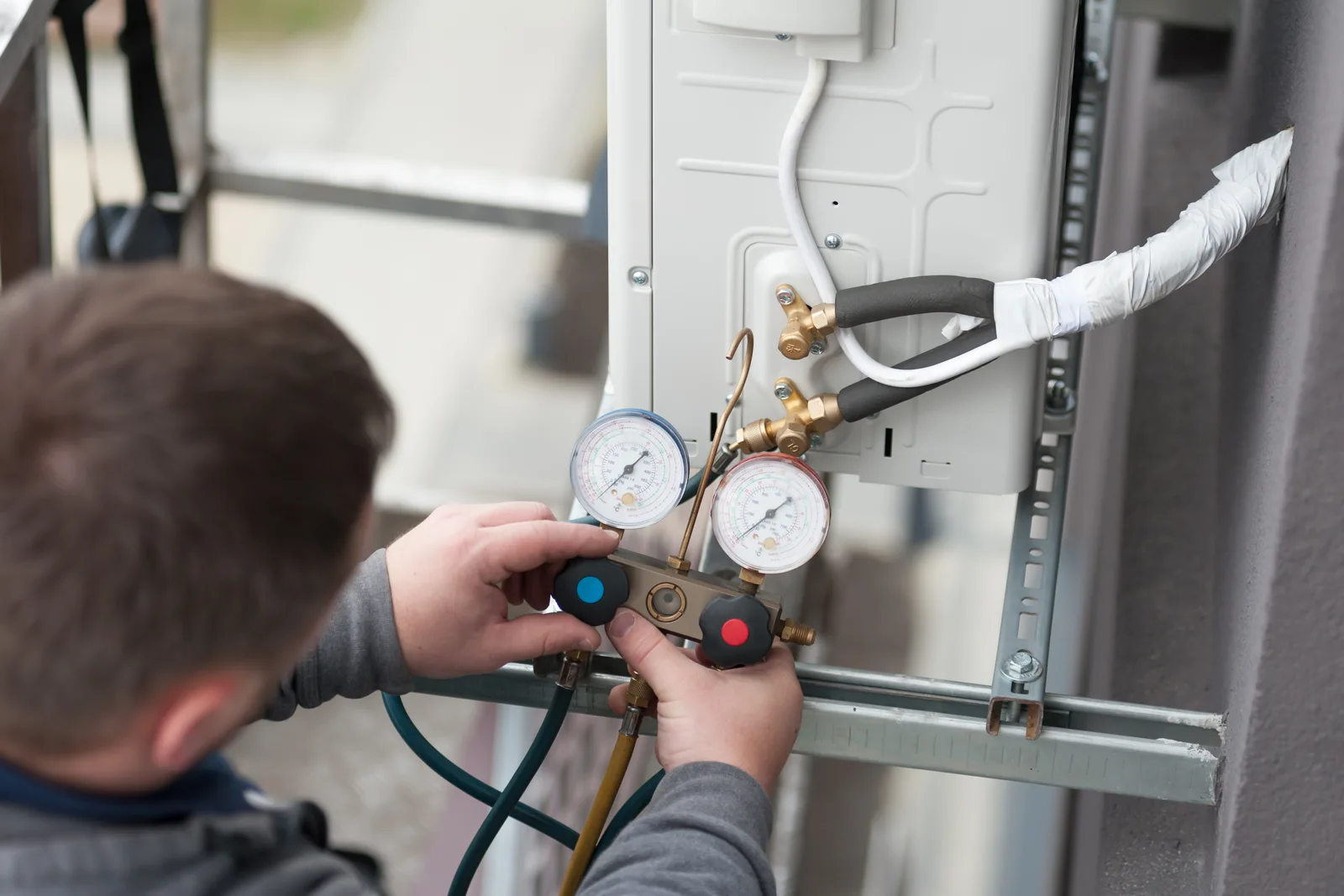 HVAC technician checking a newly installed air conditioning system